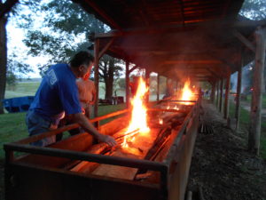 Volunteers got the fires going in the barbecue pits early Sunday morning on picnic day. Photo taken by Ursuline Associate Mary Danhauer.