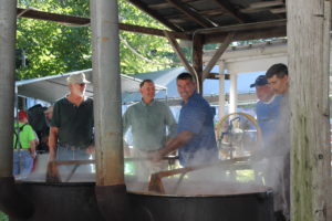 These men were smiling and talking as they stirred the vats of burgoo.
