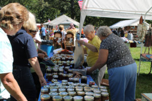 Sister Marcella Schrant, second to the right, helps a visitor with their purchase in the Crafts booth. Sister Marcella, along with Sister Grace Swift, made many of the homemade jams and jellies that were for sale.