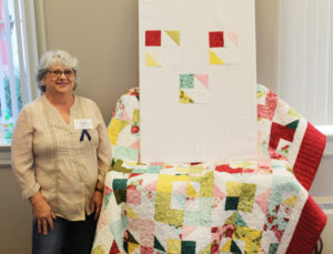Dana Hughes, of Mayfield, Ky., poses with the Day Dreaming quilt she was teaching her class to make.