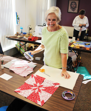 Deb Rutherford takes a break from ironing her Hunter Star blocks she’s making.