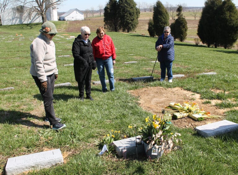 Edna Murphey, left, Sister Suzanne Sims, Aloma Dew and Merry Miller gather around the grave of Sister Dianna Ortiz, who died two years ago in February.