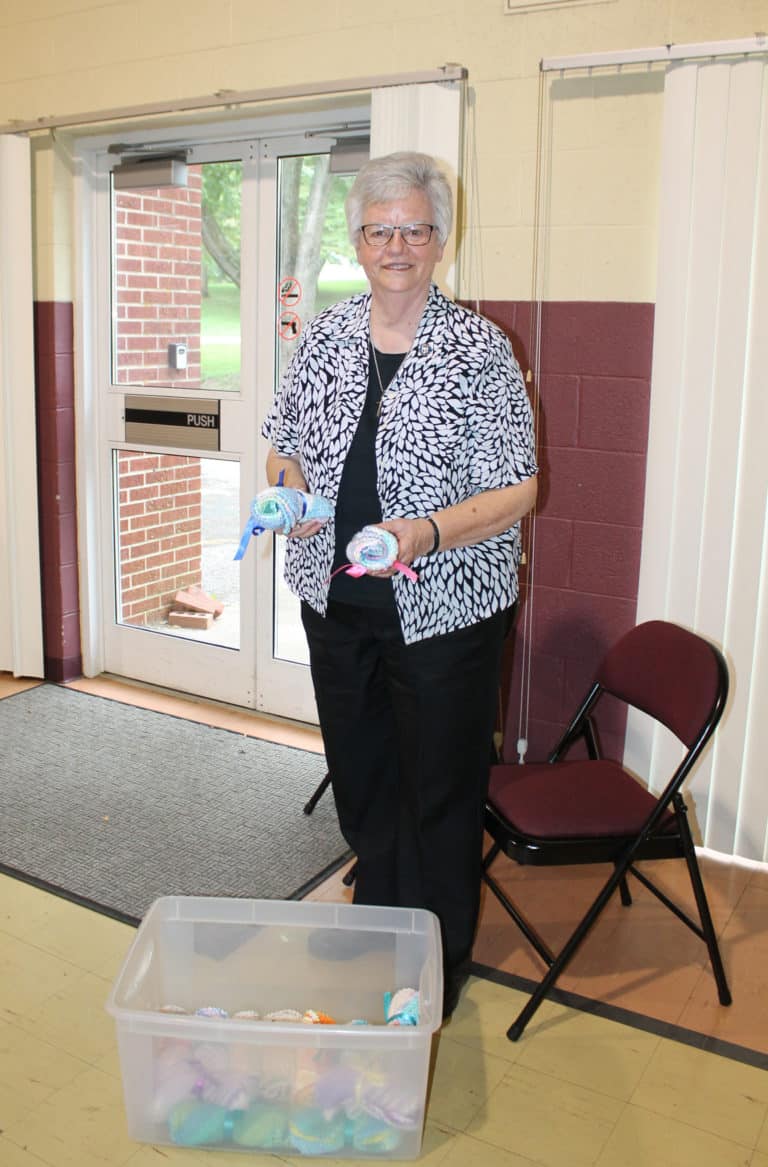 Sister Mary Timothy Bland prepares to give away handmade dish cloths to participants in the bingo. Sister Amelia Stenger's sister, Jenny, makes these cloths and donated them.
