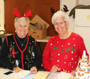 Ursuline Associates Elaine Wood, left, and Betty Boren smile as they sign cards for the sisters.