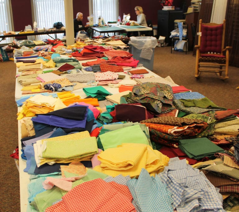 Yards and yards of donated fabric is available to the Quilting Friends to make whatever they wish during their visit.