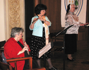 Sister Rosemary Keough, left, plays the flute along with Carolyn Sue Cecil, while Sister Rose Marita O’Bryan cantors during the 2010 Alumnae Reunion Mass.