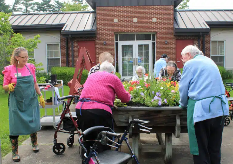 Ashley Wilkerson, left, watches the Ursuline Sisters put the finishing touches on the flower bed. Ashley Wilkerson, left, watches the Ursuline Sisters put the finishing touches on the flower bed.
