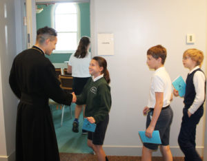 Father Ricardo Pineda, a Father of Mercy from Auburn, Ky., greets the students by name as they enter the Retreat Center Chapel.