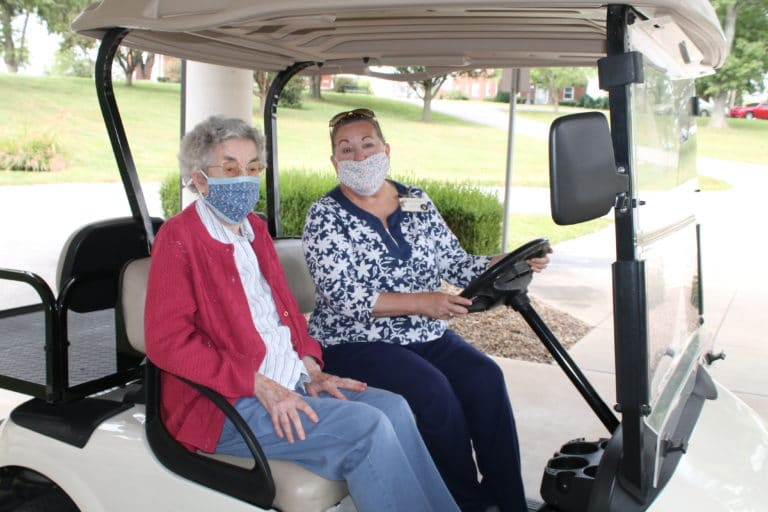 Sister Mary Gerald Payne, left, gets ready to take a trip around the Maple Mount campus in one of the Sisters’ golf carts. The driver is Debbie Dugger, activities director at Saint Joseph Villa.