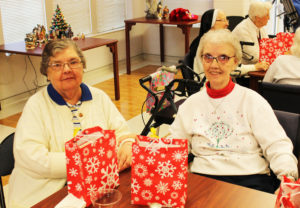 Sister Paul Marie Greenwell, left, and her sister, Sister Margaret Marie Greenwell, share time together at the party.