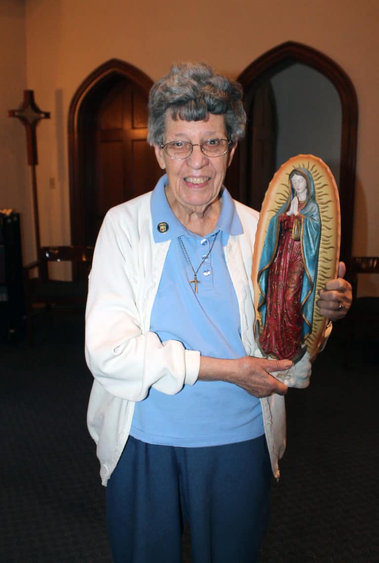 Sister Luisa Bickett smiles as she holds her statue of Our Lady of Guadalupe, which had been given to her as a gift.