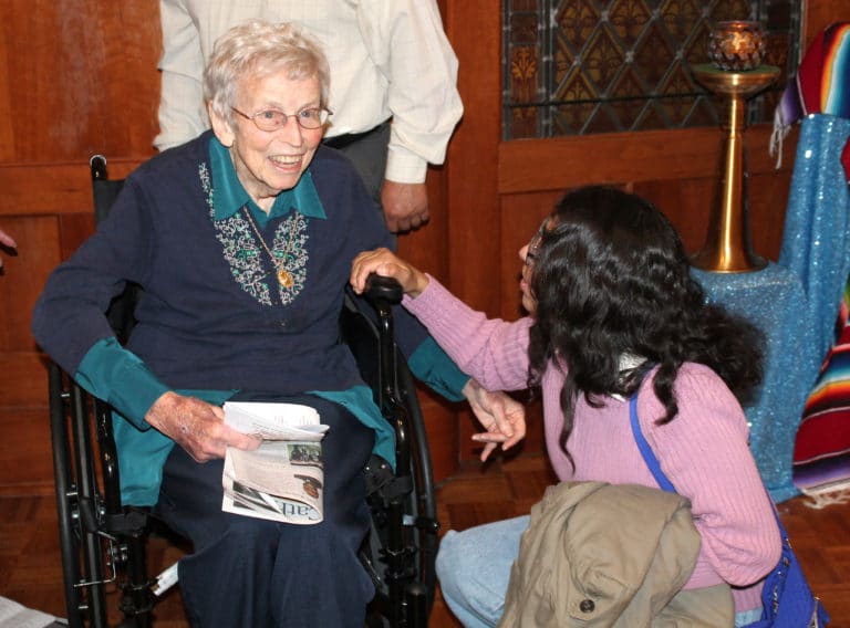 A visitor greets Sister Fran Wilhelm after the Mass.