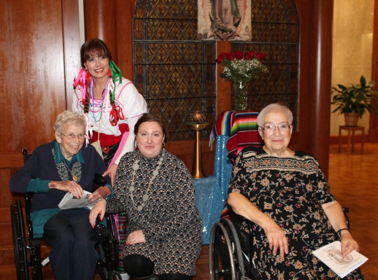 Two of the visitors greet Sister Fran Wilhelm, left, and Sister Sara Marie Gomez, right.