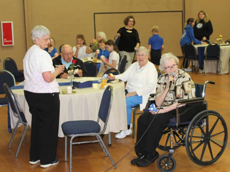 Sister Mary Celine wanted the crowd to recognize her classmate, Sister Pat Rhoten, right, who is also celebrating 60 years this year. Here, Sister Pat tells the students, “She is so proud of you at Mary Carrico Catholic School.”