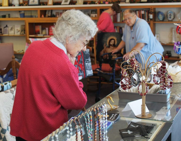 Sister Mary Gerald Payne, who has made several crafts for the Gift Shop through the years, looks over some bracelets for sale.