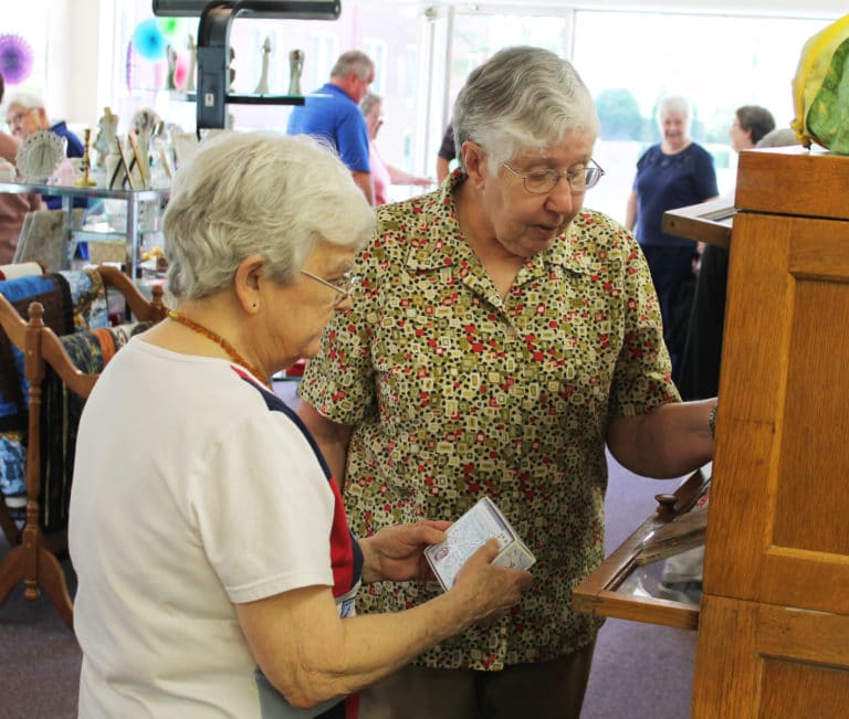 Sister Cecelia Joseph Olinger, left, and Sister Ruth Gehres consider the array of note cards available in the Gift Shop.