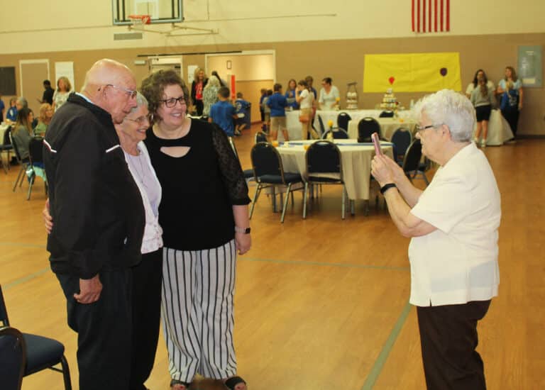 Sister Cecelia Joseph Olinger takes a photo with Marianna Romero and her father, Gene Schadler, on each side of Sister Mary Celine. Schadler was on the school board at St. Alphonsus Church when Sister Mary Celine was principal there.