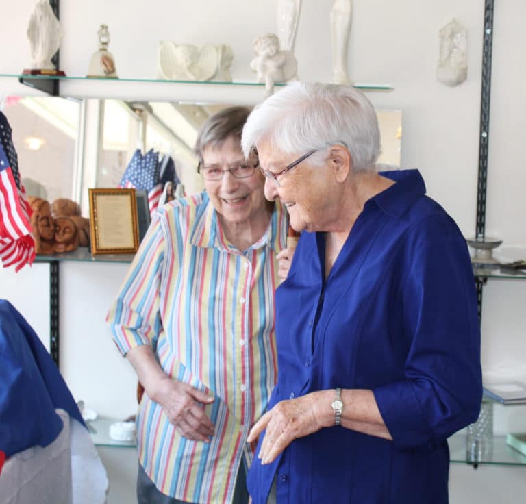 Sister Susanne Bauer, left, and Sister George Mary Hagan share a laugh as they look over items in the Gift Shop.