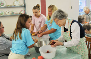 Paige Crabtree, left, of Whitesville, Amelia Guenther, center, of Kansas, and Maggie Foster, of Whitesville, work with Sister Catherine Barber, right, and Sister Stephany Nelson, left.