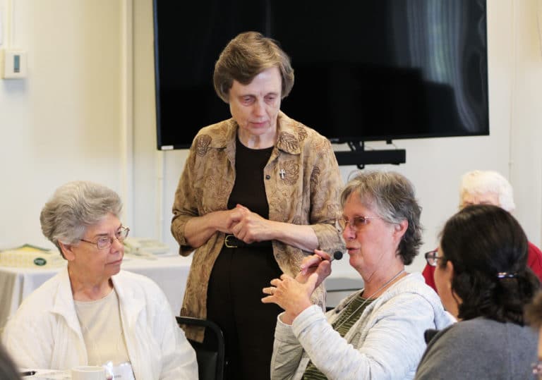 Ursuline Sister Mary Ellen Backes, who serves in Springfield, Ill., discusses her thoughts about a picture of the visitation of Mary and Elizabeth. Listening are Sister Nancy Murphy, left, and Sister Lynn Jarrell.