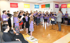 Nick Botkins, the camp director, leads the students in singing a hymn by a Japanese composer in the Rainbow Room of Saint Joseph Villa. Botkins brought the camp to the Mount for the first time in 2010 because he regularly attended Music Camp at Maple Mount as a teenager.