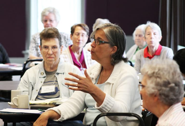 Ursuline Sister Larraine Lauter, center, makes a point as Sister Sharon Sullivan and other sisters listen.