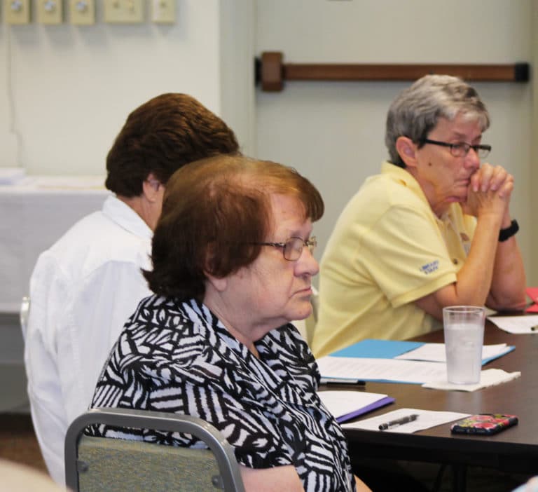 Ursuline Sister Rosanne Spalding, center, follows the discussion with Sister Judith Nell Riney, right, and Sister Margaret Ann Aull (partially hidden).