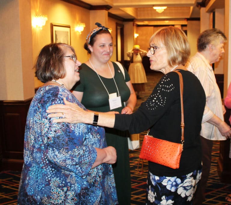 Ursuline Associates of Mount Saint Joseph Joanne Thompson, left, and Renee Schultz, center, both of Kansas, meet Rosann Whiting, an Ursuline Associate from Paducah, Ky., prior to the opening ritual. Whiting is executive director of the Ursuline Education Network, which was sponsoring the opening evening.