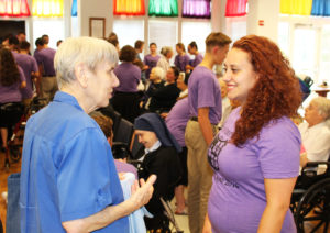 Sister Sheila Anne Smith, left, made a new friend talking with this camp member.