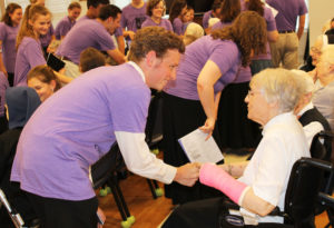 Sister Marie Goretti Browning gets a handshake from this camp member.