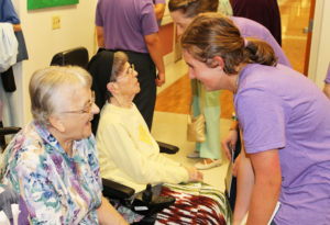 Sister Dorothy Helbling finds something funny while talking to this young lady.