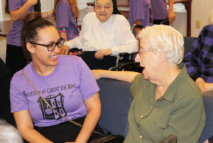 Sister Eva Boone must have said something funny as she gets a big laugh from this camp member.