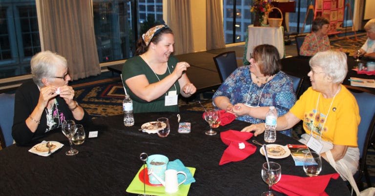 Kansans know how to have a good time at the Convocation, as they share a laugh during the opening night reception. From left are Ursuline Associates Janice Arth, Renee Schultz and Joanne Thompson, along with Ursuline Sister Angela Fitzpatrick.