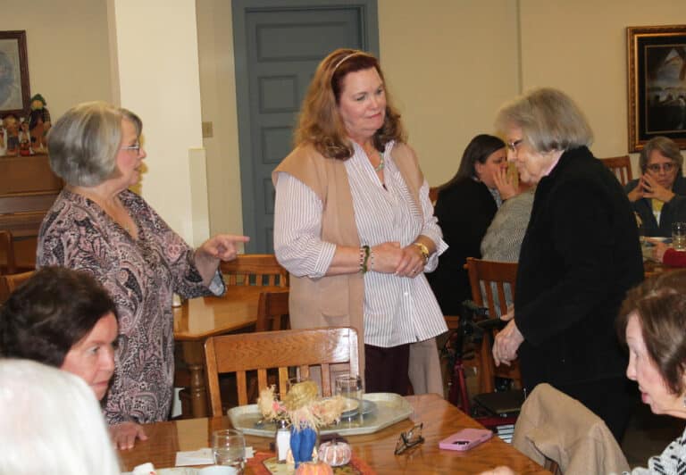 Elaine, center, accepts well wishes from Sister Catherine Barber, right, as her sister-in-law and retired Mount employee Audrey Clouse looks on.
