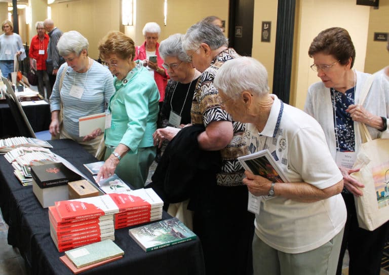 Ursuline Sisters of Mount Saint Joseph gather around one of the display tables to look over Ursuline books that were available for a donation. From left are Sisters Pam Mueller, Elaine Burke, Nancy Murphy, Ruth Gehres, Marcella Schrant and Mary Henning.