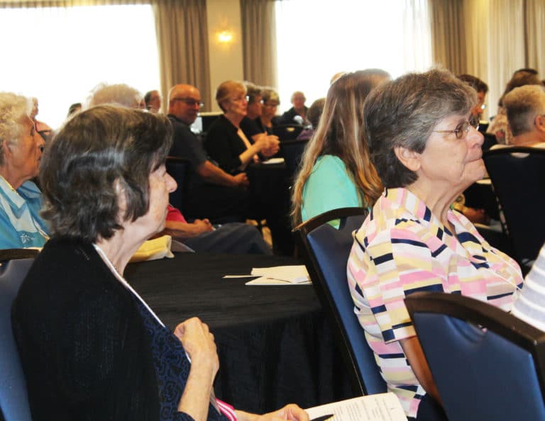 Mary-Cabrini Durkin, left, of the Company of Saint Ursula, and Sister Cheryl Clemons, of Mount Saint Joseph, listen to Sister Teresa Maya’s speech. Sister Teresa urged everyone to stay connected to their founding story. “Heritage is what you receive. Legacy is what you leave,” she said. “What will your legacy be as Angela’s family?”