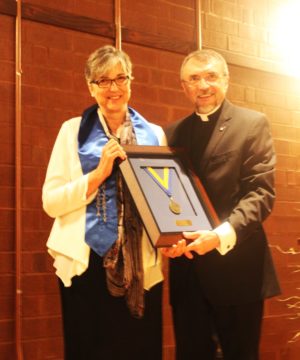 Sister Larraine Lauter holds her plaque naming her one of Brescia University’s 2015 Distinguished Alumni along with Father Larry Hostetter, president of Brescia. The ceremony was held Sept. 19 at Owensboro’s RiverPark Center.