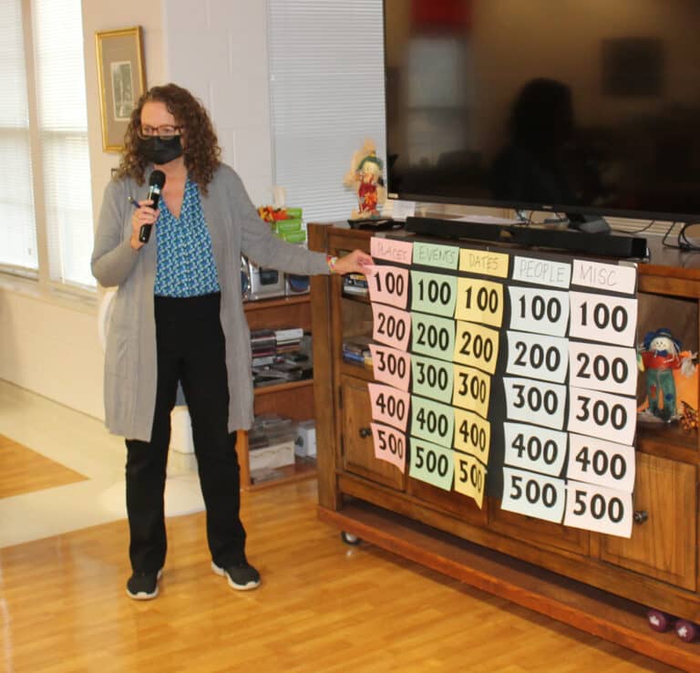Ashley Wilkerson, pastoral care and activities coordinator for the Villa Sisters, goes over the categories and dollar amounts for Ursuline Jeopardy.