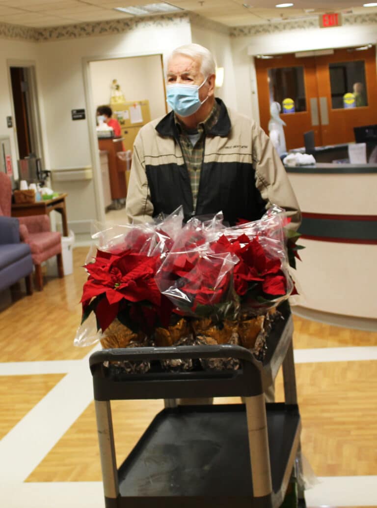 Associate Mike Sullivan pushed the poinsettia cart to each Sisters’ room.