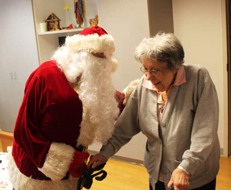 Sister Luisa Bickett smiles for Santa after he delivers her presents. Once again, Associate John Wood was nowhere to be found when Santa was present.
