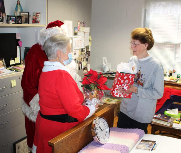 Sister Claudia Hayden is happy to accept her present from the Associates, just before 11 a.m.