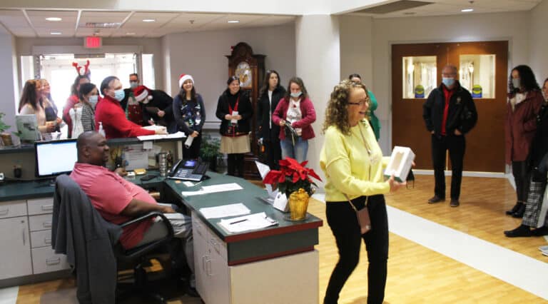 Ashley Wilkerson, in the yellow top, coordinator of Activities and Pastoral Care for the Sisters in Saint Joseph Villa, and Mario Palmer, receptionist, welcome the diocesan staff on Dec. 6. With increases in flu and Covid in Daviess County, visitors are asked to wear masks in the Villa. Ashley Wilkerson, in the yellow top, coordinator of Activities and Pastoral Care for the Sisters in Saint Joseph Villa, and Mario Palmer, receptionist, welcome the diocesan staff on Dec. 6. With increases in flu and Covid in Daviess County, visitors are asked to wear masks in the Villa.