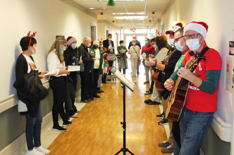 The diocesan staff line one of the hallways for a rousing rendition of 
“We Wish You a Merry Christmas.”