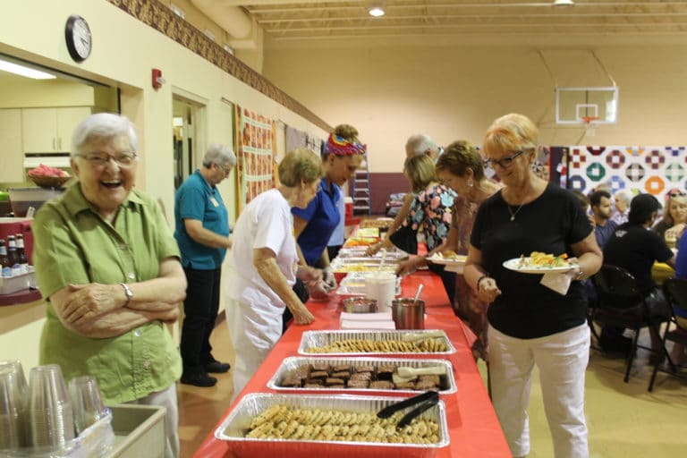 Sister George Mary is happy to help serve food and drinks to the guests Sister George Mary is happy to help serve food and drinks to the guests
