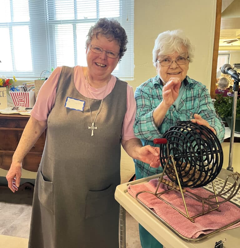 Glenmary Sister Darlene Presley, left, and Sister Cecelia Joseph Olinger get ready to pick out another bingo ball for some lucky winner. Sister Darlene is on the Steering committee.