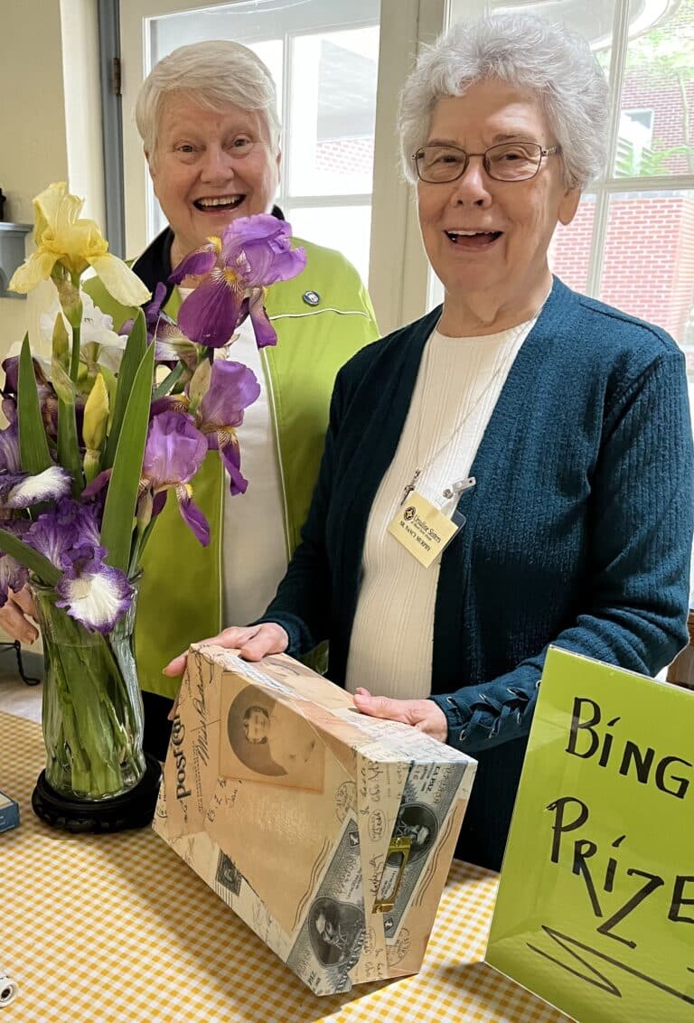 Sister Suzanne Sims, left, and Sister Nancy Murphy monitor the gift table.