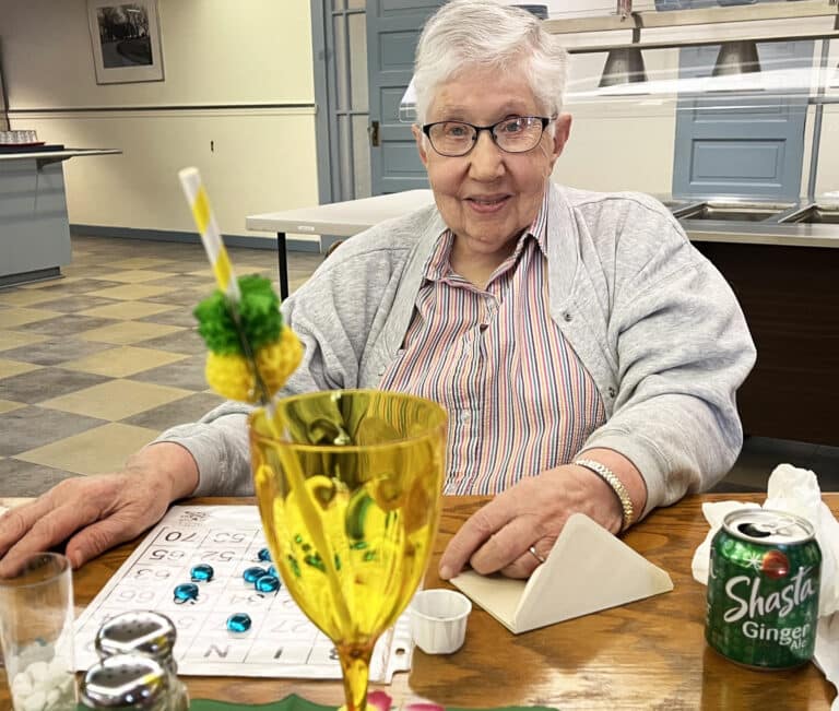Sister Ruth Gehres enjoys some ginger ale and a game of bingo.