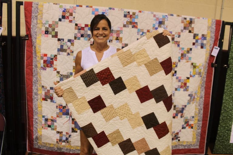 One of the first winners and the quilt she picked out!
