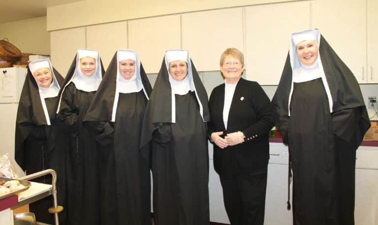 Sister Amelia Stenger, second from right, who organized the reception for the day, poses with the actors who were portraying the pioneer Ursuline Sisters in the play “Legacy Sisters.” From left are Mary-Katherine Maddox, Calli Whitmore, Rebecca Volk, Meredith Keller and Kristin Whitney.