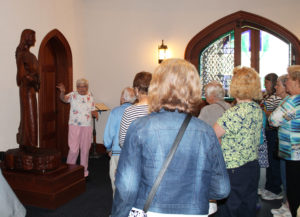 Sister George Mary talks about the wooden statue of Saint Angela Merici that greets visitors entering the chapel. The hand-carved statue came from the motherhouse of the Ursulines of Paola, Kan., after the merger of the two communities.